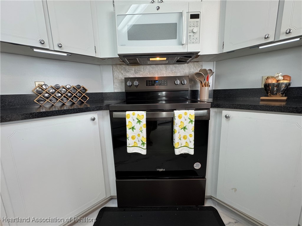 2940 Louis Street Sebring, FL 33872 - Photo 26 of 47 a kitchen with stainless steel appliances and cabinets