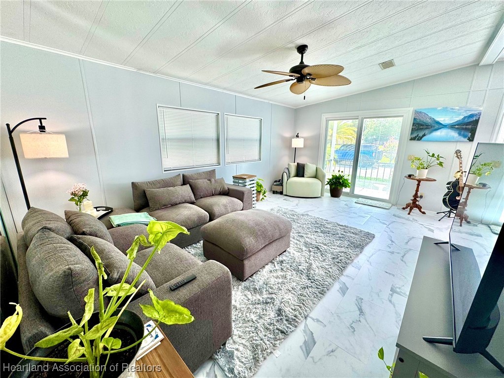 2940 Louis Street Sebring, FL 33872 - Photo 4 of 47 a living room with furniture and a chandelier