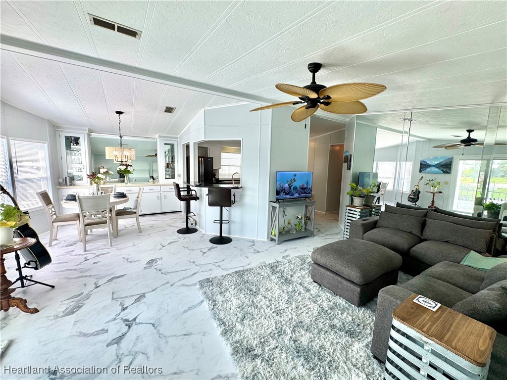 2940 Louis Street Sebring, FL 33872 - Photo 5 of 47 a living room with furniture and a chandelier