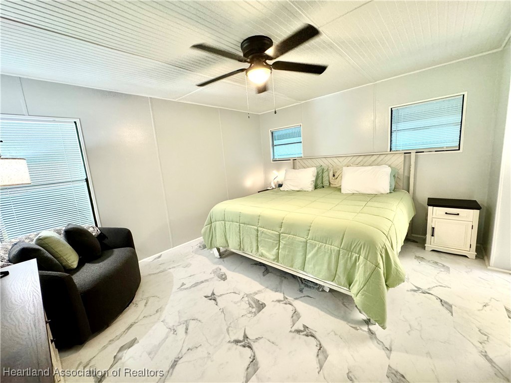 2940 Louis Street Sebring, FL 33872 - Photo 10 of 47 a bedroom with a bed and couch