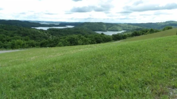 a view of field with trees in the background