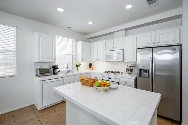 a kitchen with a sink a stove and refrigerator
