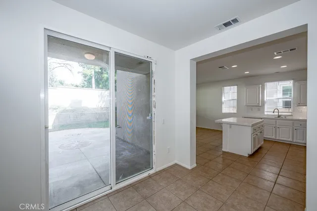 a view of a kitchen with kitchen island granite countertop counter space and windows