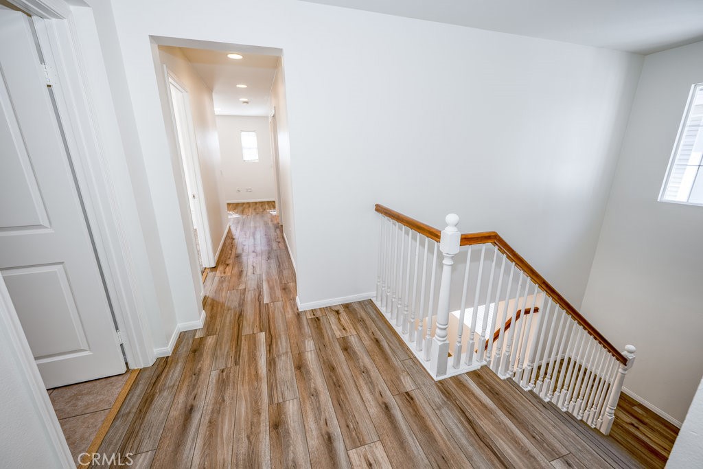 23321 Beachcomber Lane Valencia, CA 91355 - Photo 19 of 40 Staircase and upper-level landing with wood flooring — transition zone to private bedrooms in the home.
