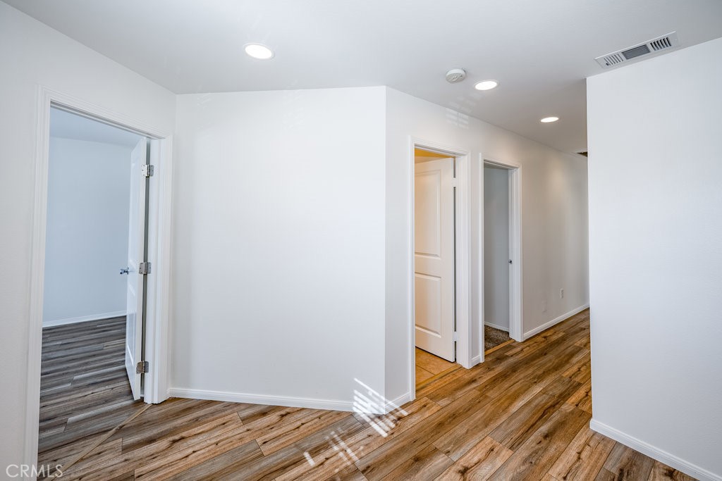 23321 Beachcomber Lane Valencia, CA 91355 - Photo 31 of 40 Hallway view upstairs with wood flooring and windows — connects bedrooms and common spaces smoothly.