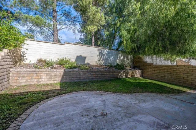 a view of a backyard with table and chairs and a fire pit
