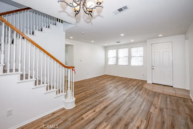 a view of an entryway with wooden floor