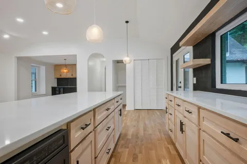 a spacious bathroom with double vanity and a mirror