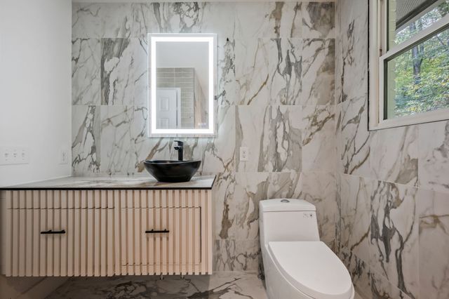 a bathroom with a toilet and a shower curtain