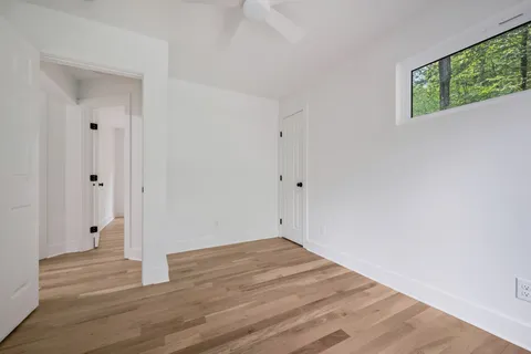a view of room with wooden floor and window