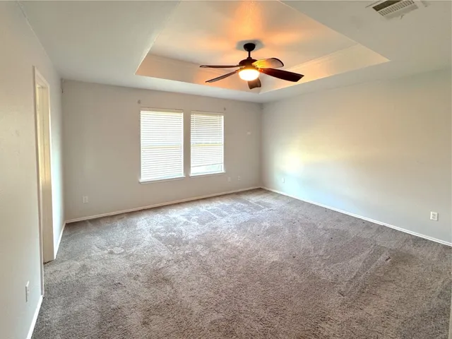en view interior of a house with a ceiling fan and window