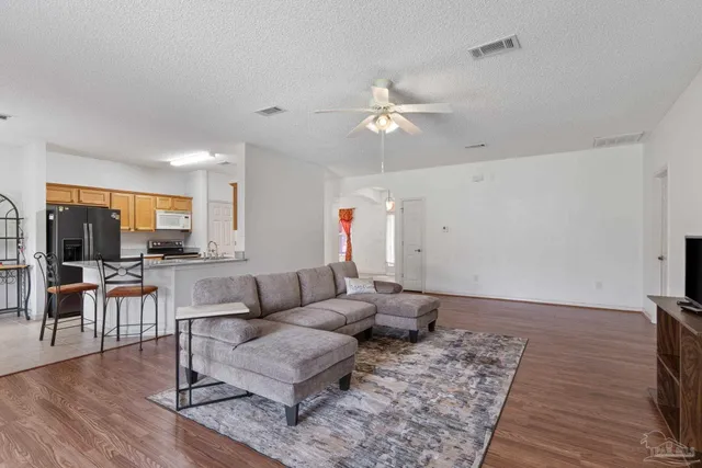 a living room with furniture and wooden floor