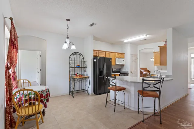 a view of a dining room with furniture and chandelier