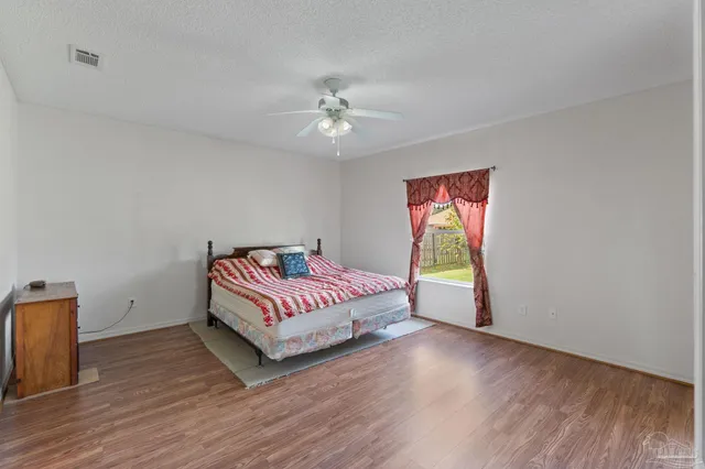 a bedroom with a large bed and a chandelier