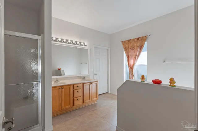 a bathroom with a sink vanity and mirror