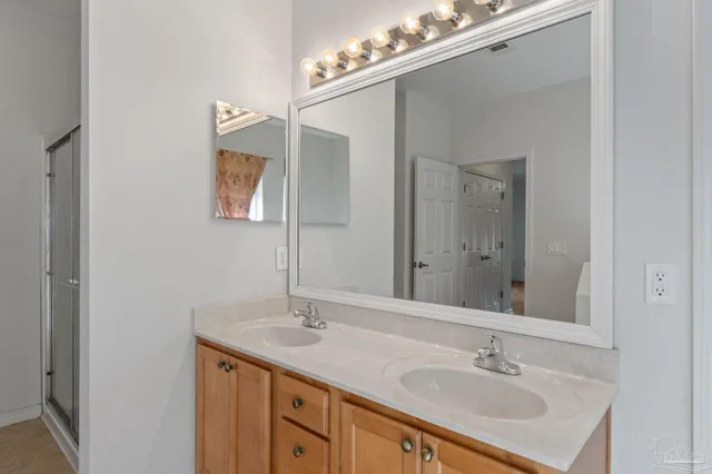 a bathroom with a tub a sink and mirror