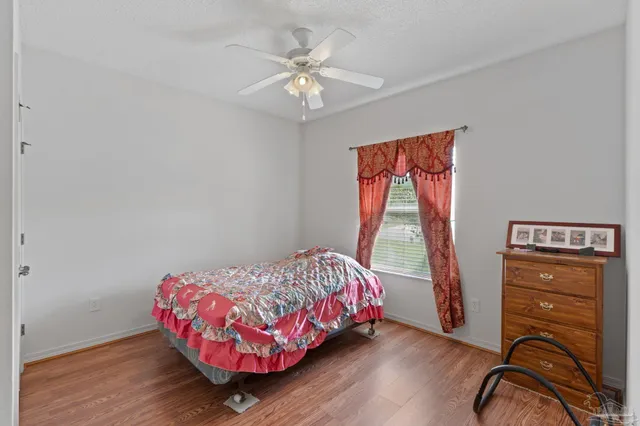 a bathroom with a granite countertop sink toilet a mirror and shower