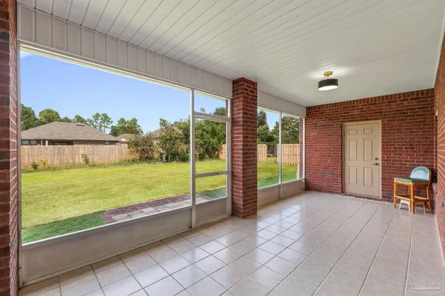 a view of a porch with a table and chairs
