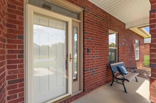 a brick building with a bench and a window