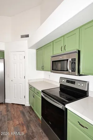 a kitchen with a refrigerator and cabinets