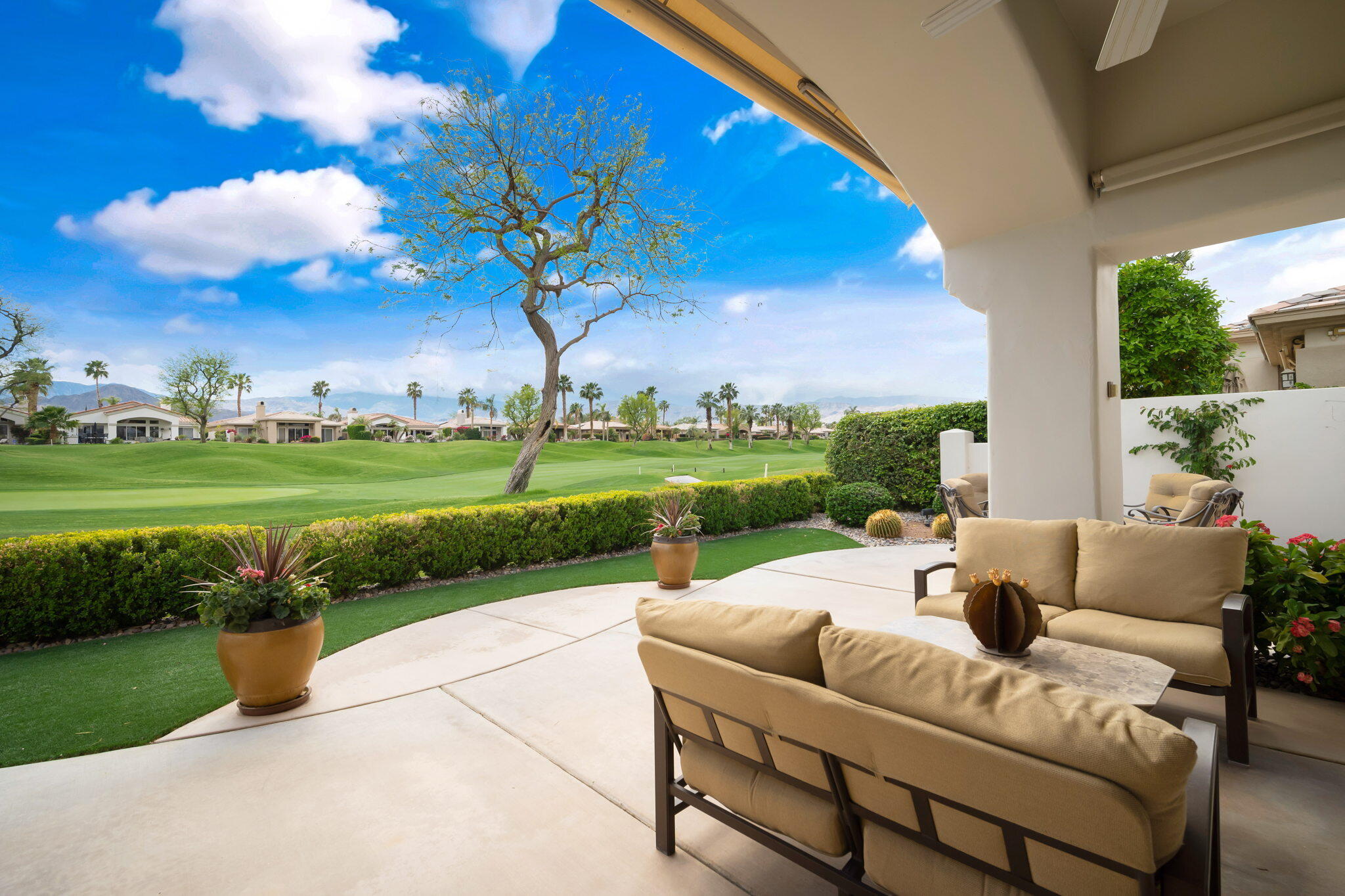 a view of a patio with couches and a big yard
