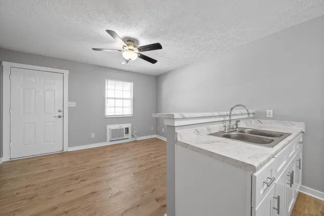a kitchen with a sink stove and cabinets