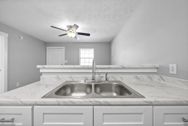 a kitchen with a sink and a stove