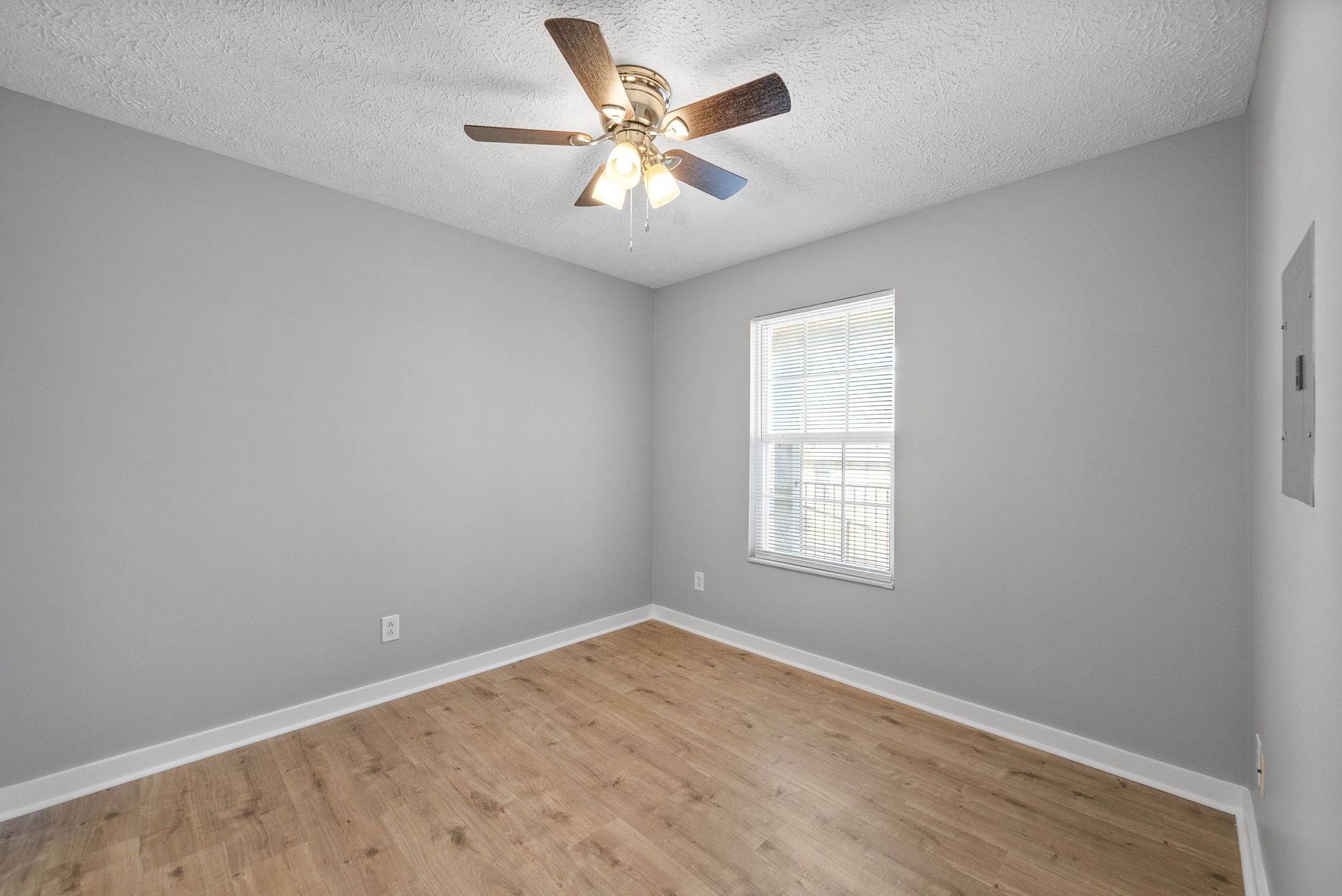 765 Robb Avenue, Unit 2 Clarksville, TN 37040 - Photo 22 of 24 an empty room with a window and a ceiling fan