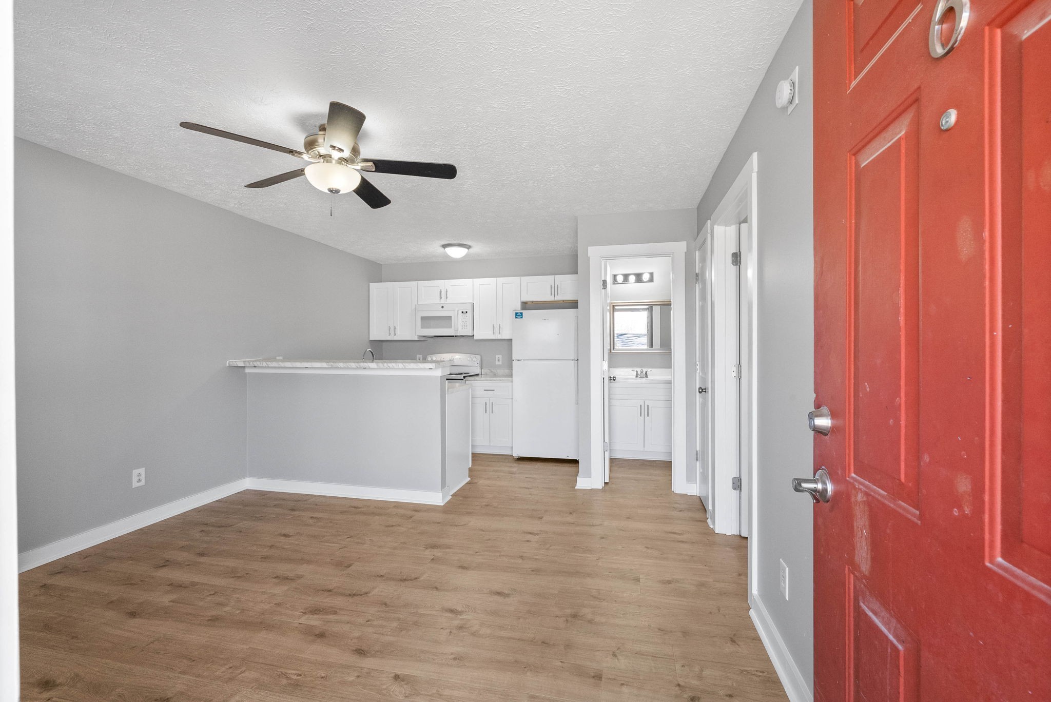 765 Robb Avenue, Unit 2 Clarksville, TN 37040 - Photo 8 of 24 a view of a kitchen with wooden floor and a ceiling fan