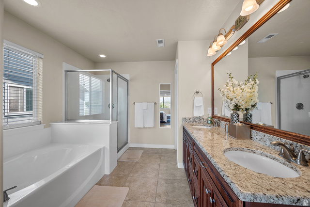 955 Delorean Lane Midvale, UT 84047 - Photo 20 of 47 Bathroom featuring a double vanity with granite countertops, wood-finish cabinetry, and undermount sinks