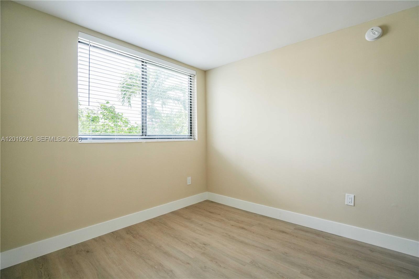 6960 Rue Vendome, Unit 201 Miami Beach, FL 33141 - Photo 14 of 27 an empty room with wooden floor and windows