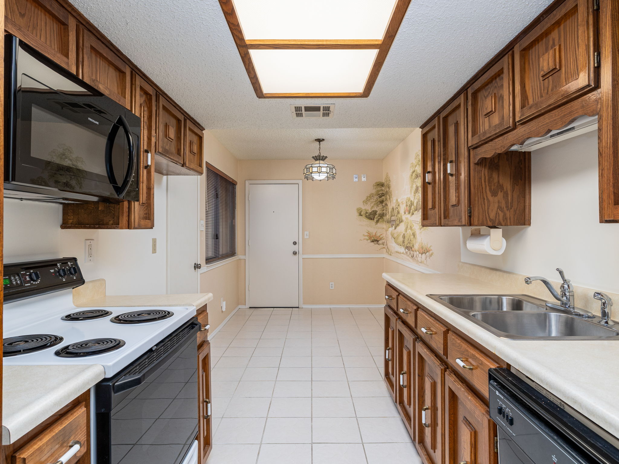 8216 Summer Side Drive Austin, TX 78759 - Photo 12 of 32 The kitchen and second dining area with door to the garage
