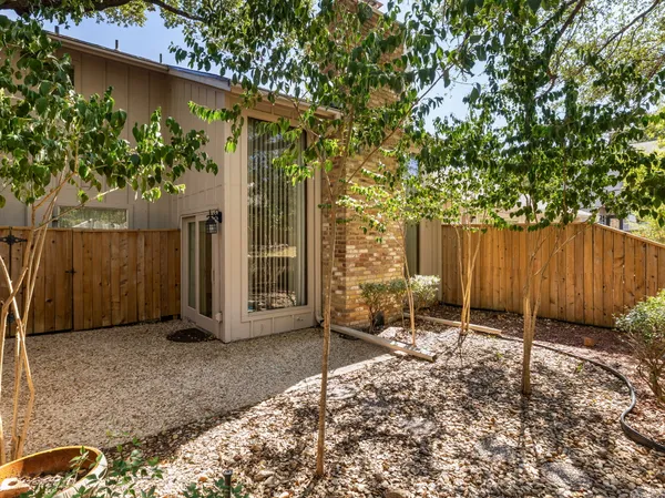 a backyard of a house with table and chairs