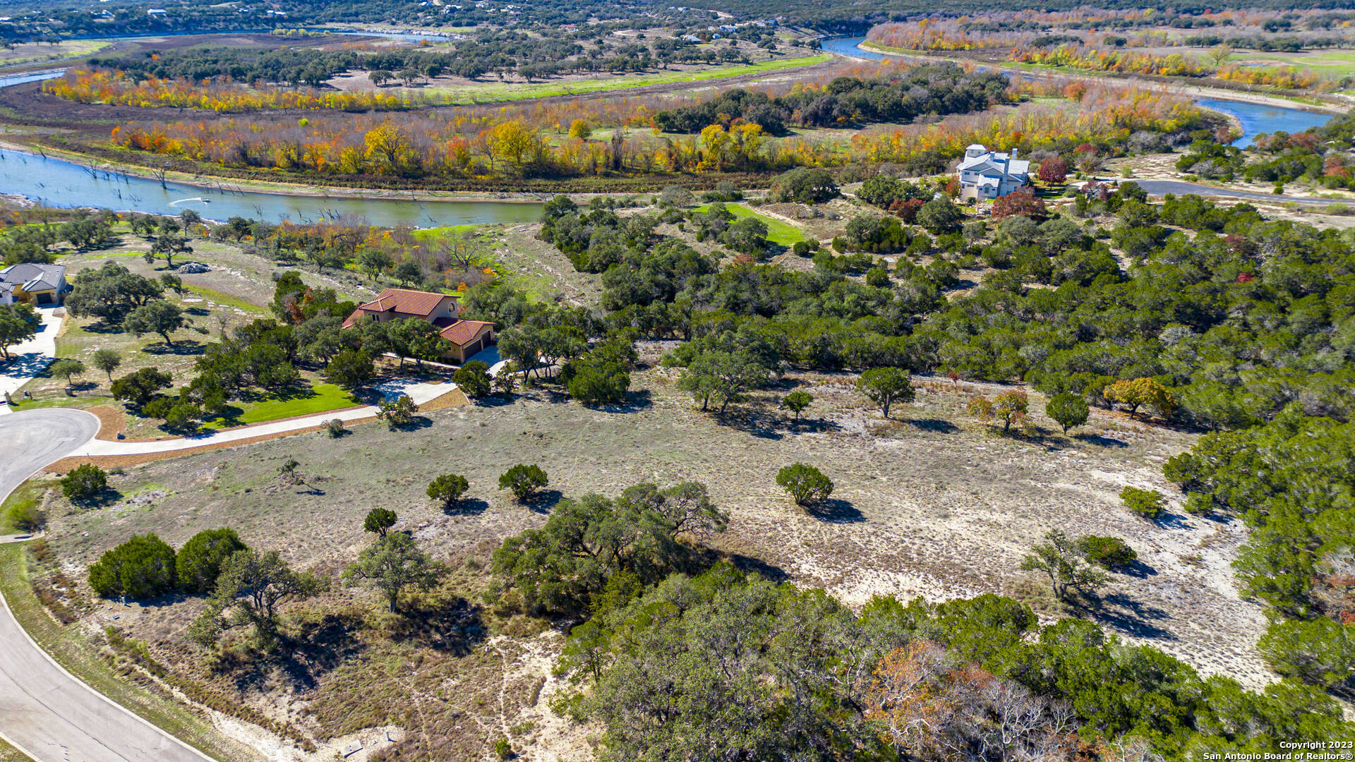 150 Riddle Road Spring Branch, TX 78070 - Photo 23 of 38 a view of a lake with a building in the back