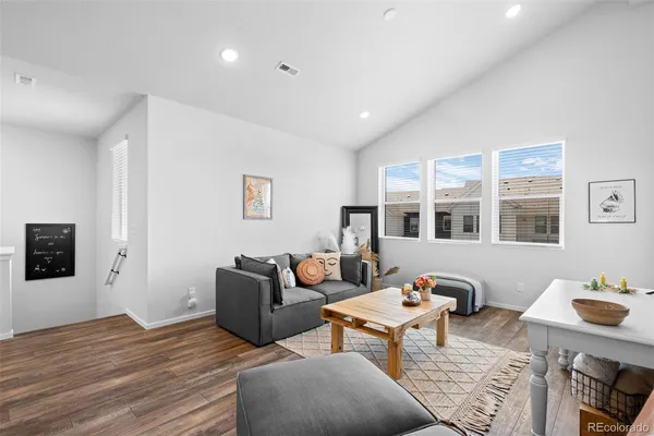 a living room with furniture and wooden floor