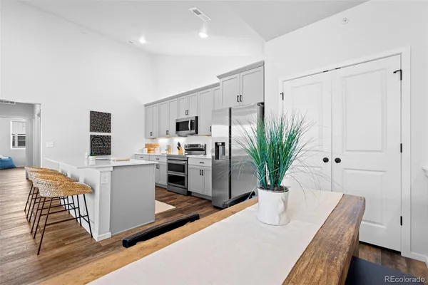 a view of a kitchen with furniture and wooden floor