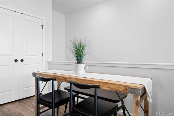 a table with chairs and wooden floor