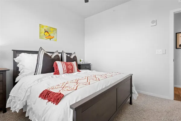 a bedroom with a bed and a painting on the wall