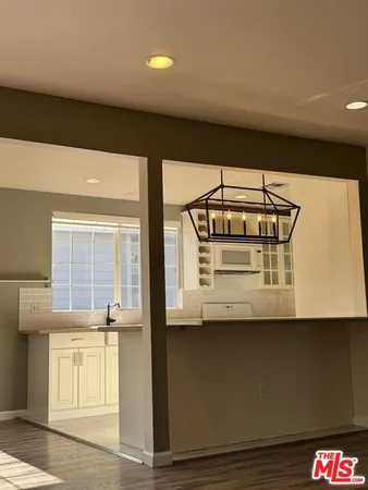 a bathroom with a sink a toilet a mirror and shower
