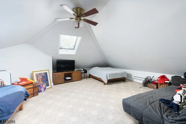 a bedroom with furniture and a flat screen tv