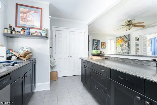 a spacious bathroom with a granite countertop sink a toilet and a mirror