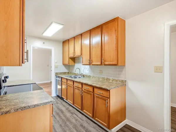a kitchen with granite countertop cabinets and sink