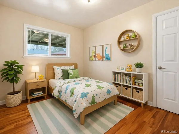 a bedroom with a bed a bookshelf and a potted plant