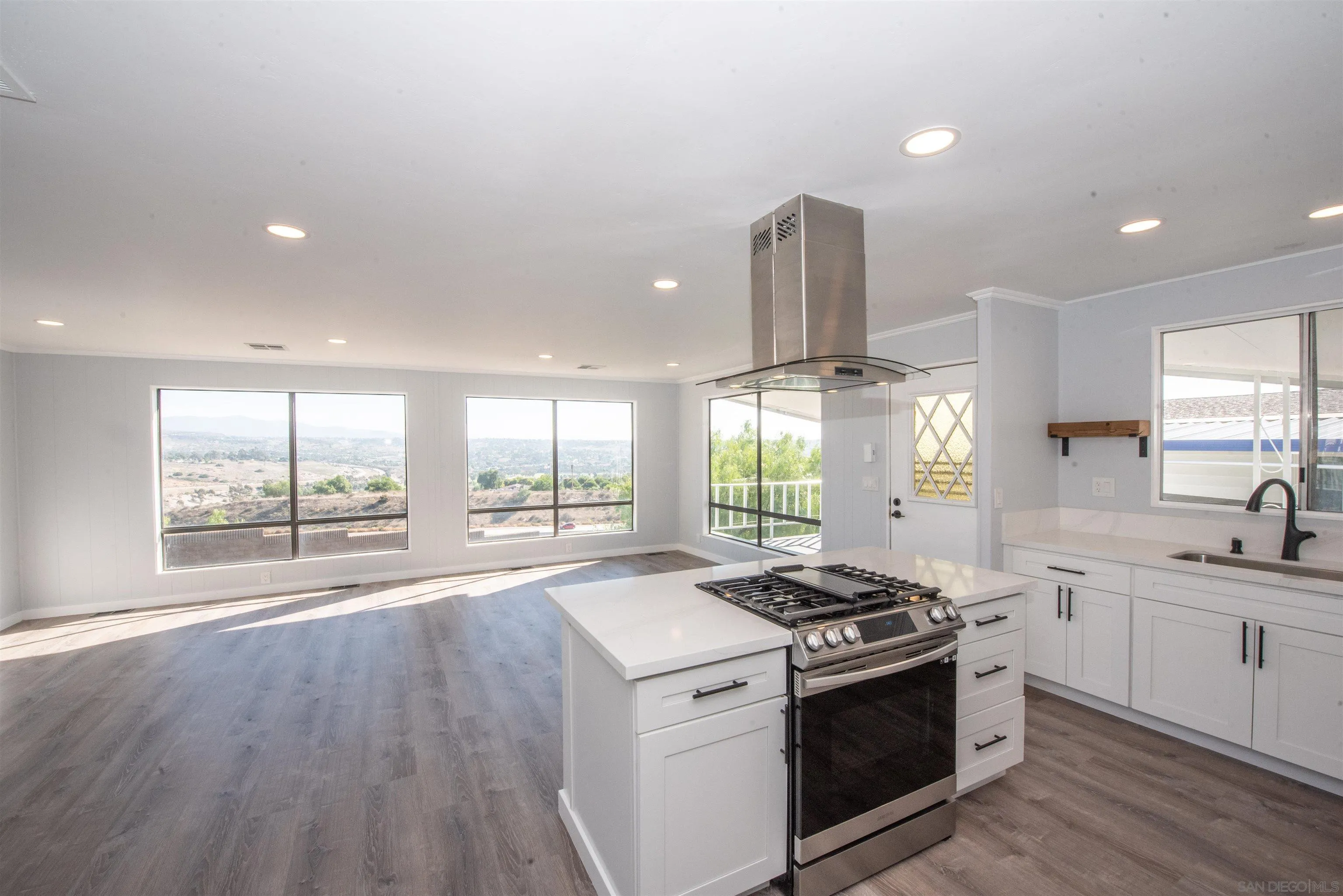 275 South Worthington Street, Unit 36 Spring Valley, CA 91977 - Photo 1 of 44 a kitchen with a stove a sink and wooden floor