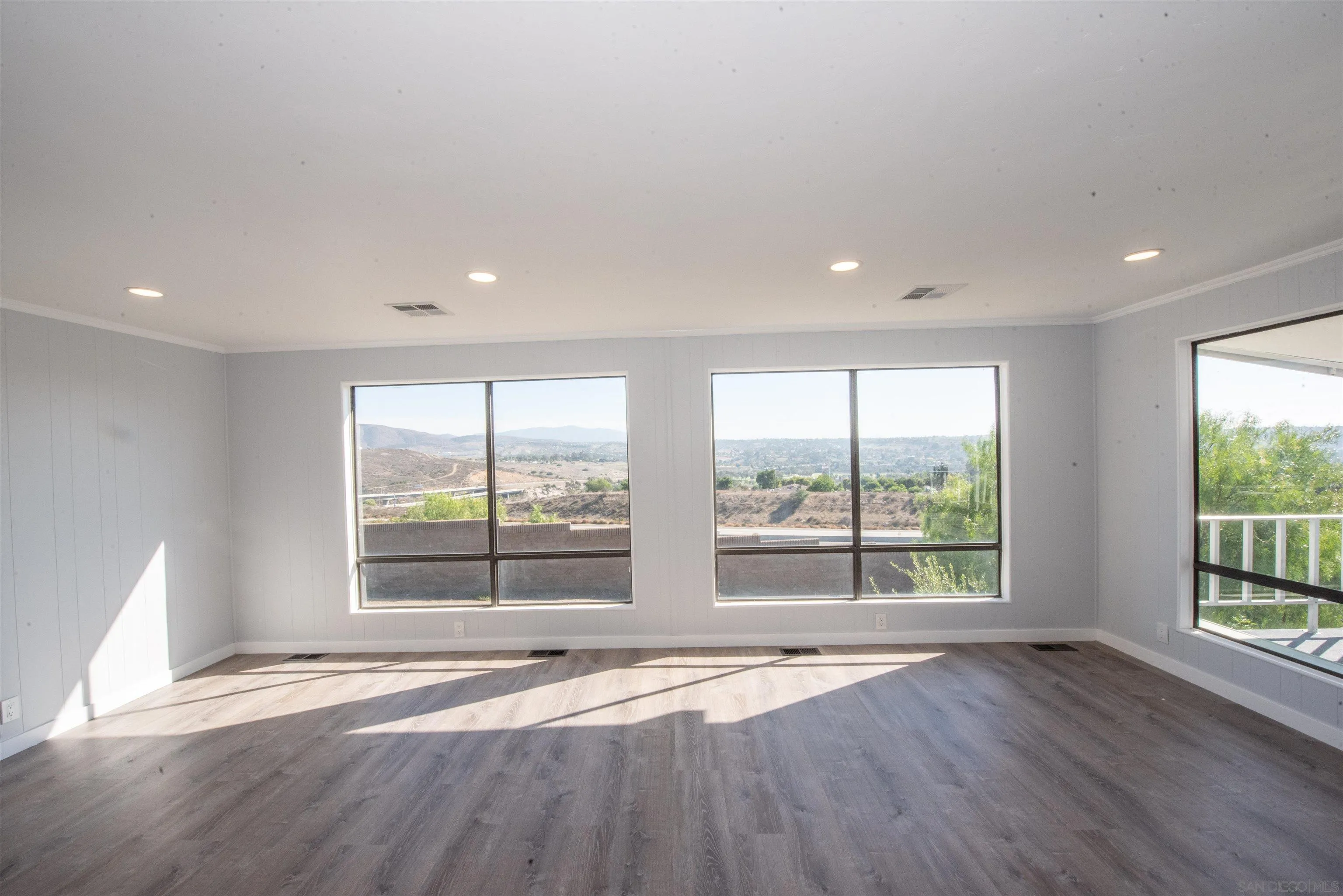 275 South Worthington Street, Unit 36 Spring Valley, CA 91977 - Photo 12 of 44 a view of an empty room with wooden floor and a window