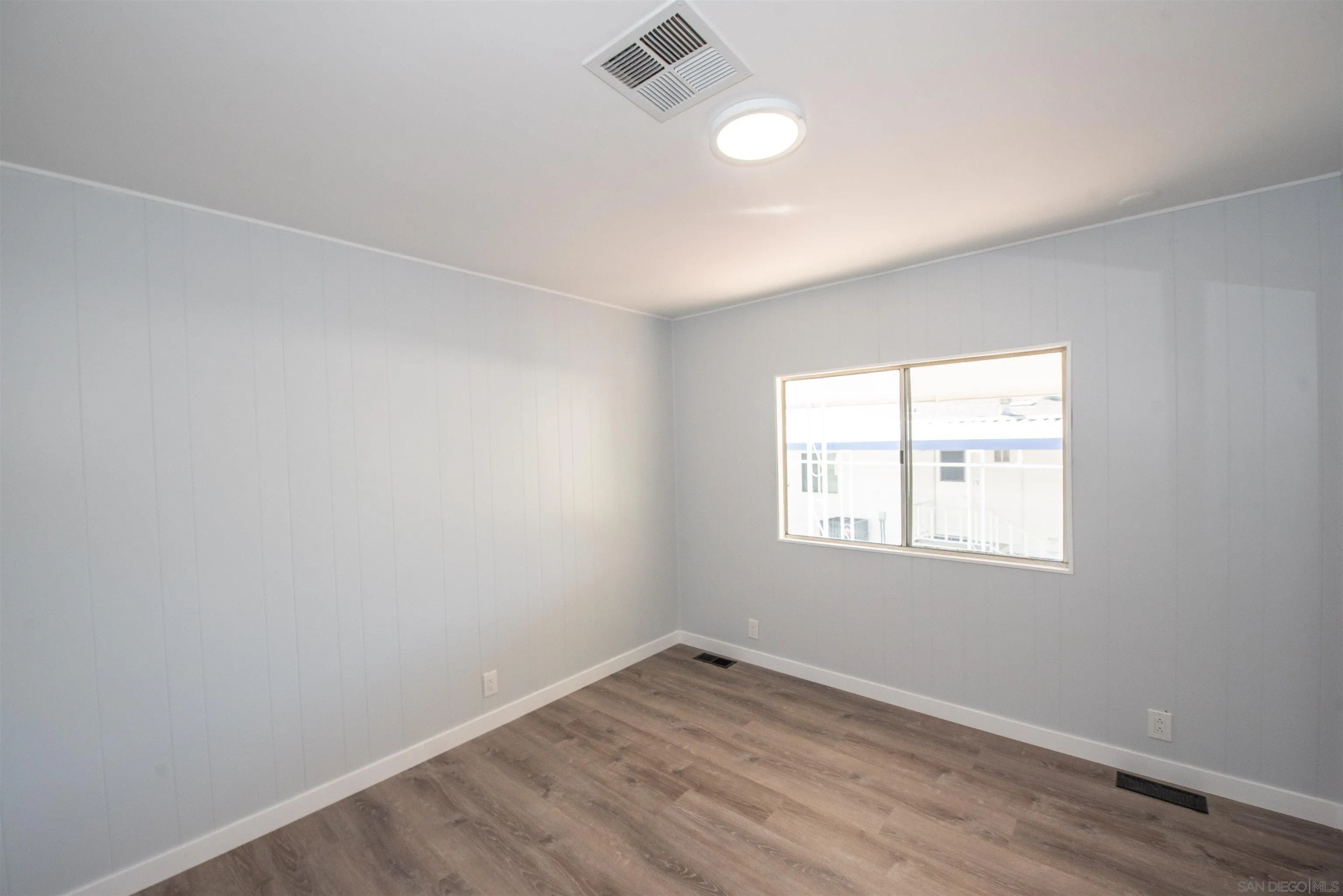 275 South Worthington Street, Unit 36 Spring Valley, CA 91977 - Photo 15 of 44 an empty room with wooden floor and windows