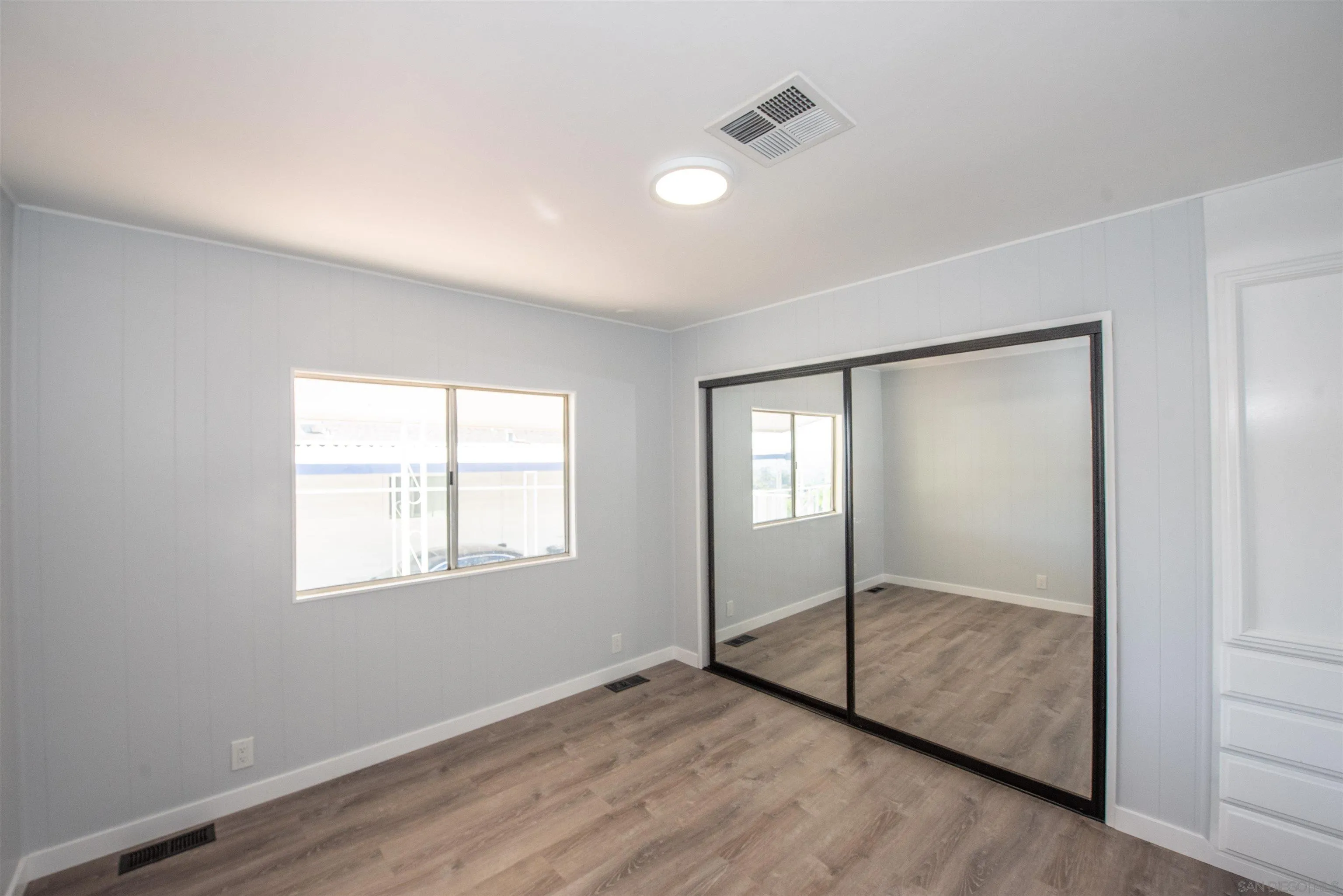275 South Worthington Street, Unit 36 Spring Valley, CA 91977 - Photo 16 of 44 a view of an empty room with wooden floor and a window