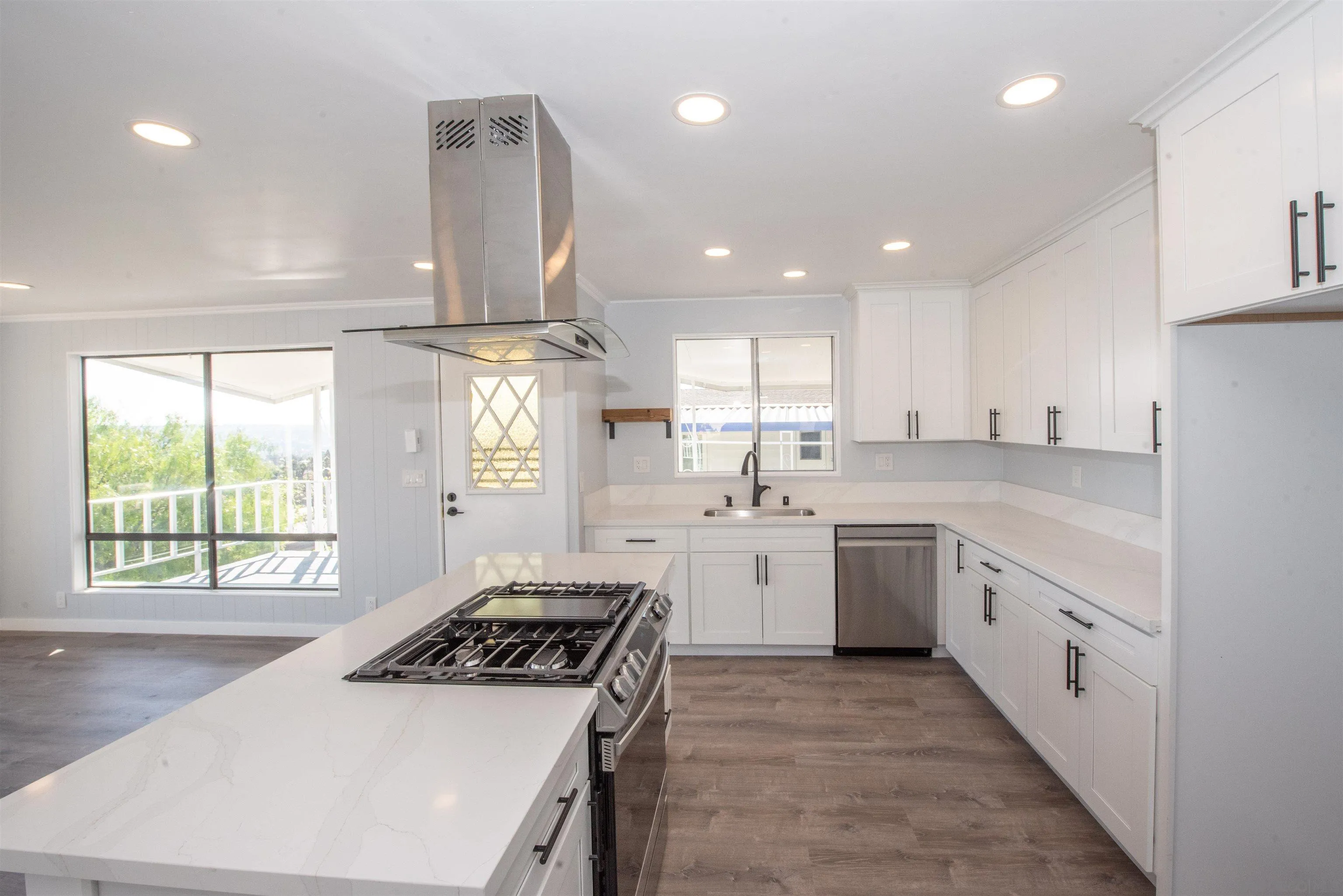 275 South Worthington Street, Unit 36 Spring Valley, CA 91977 - Photo 2 of 44 a kitchen with a stove a sink a center island and windows
