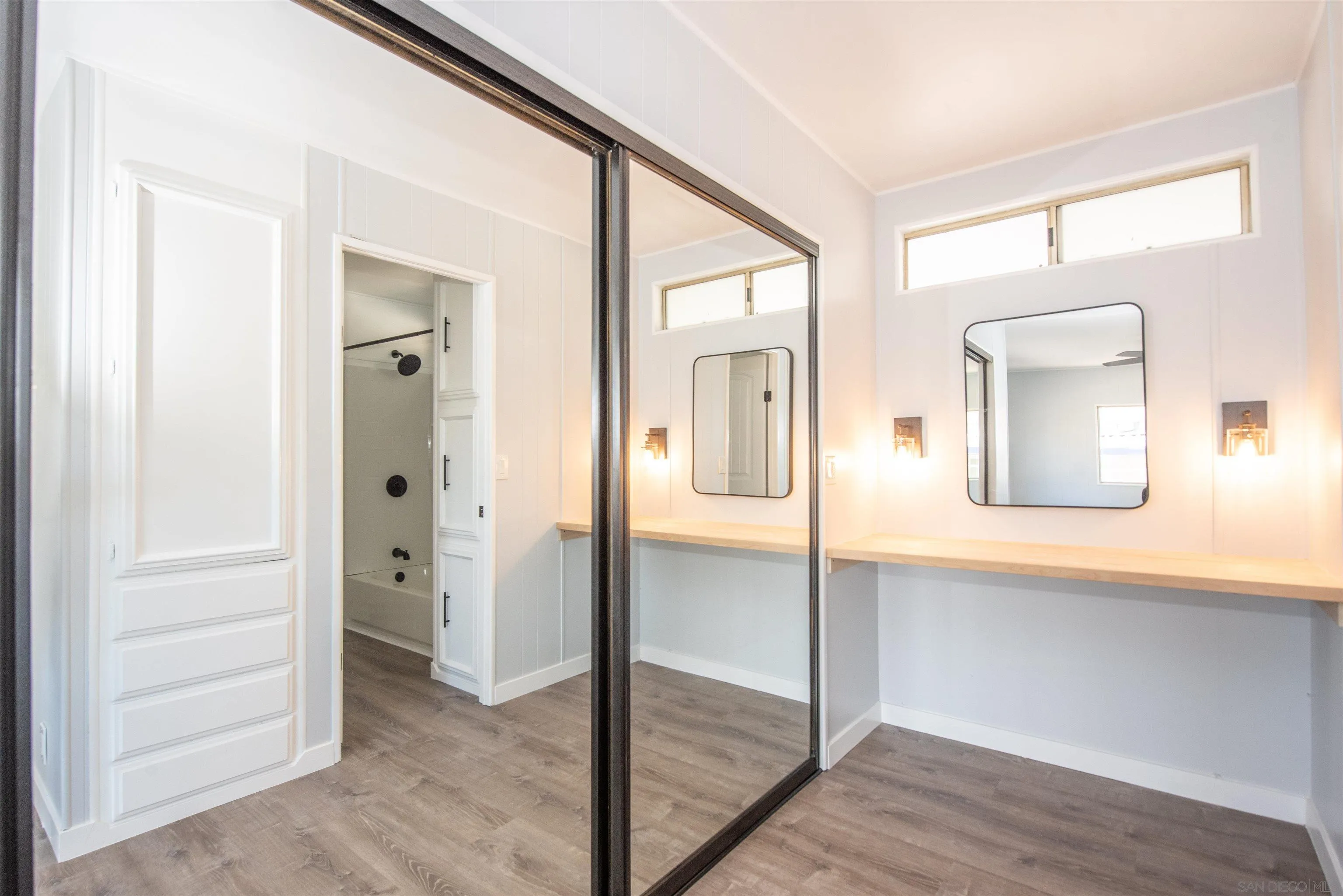 275 South Worthington Street, Unit 36 Spring Valley, CA 91977 - Photo 21 of 44 an empty room and mirror with wooden floor