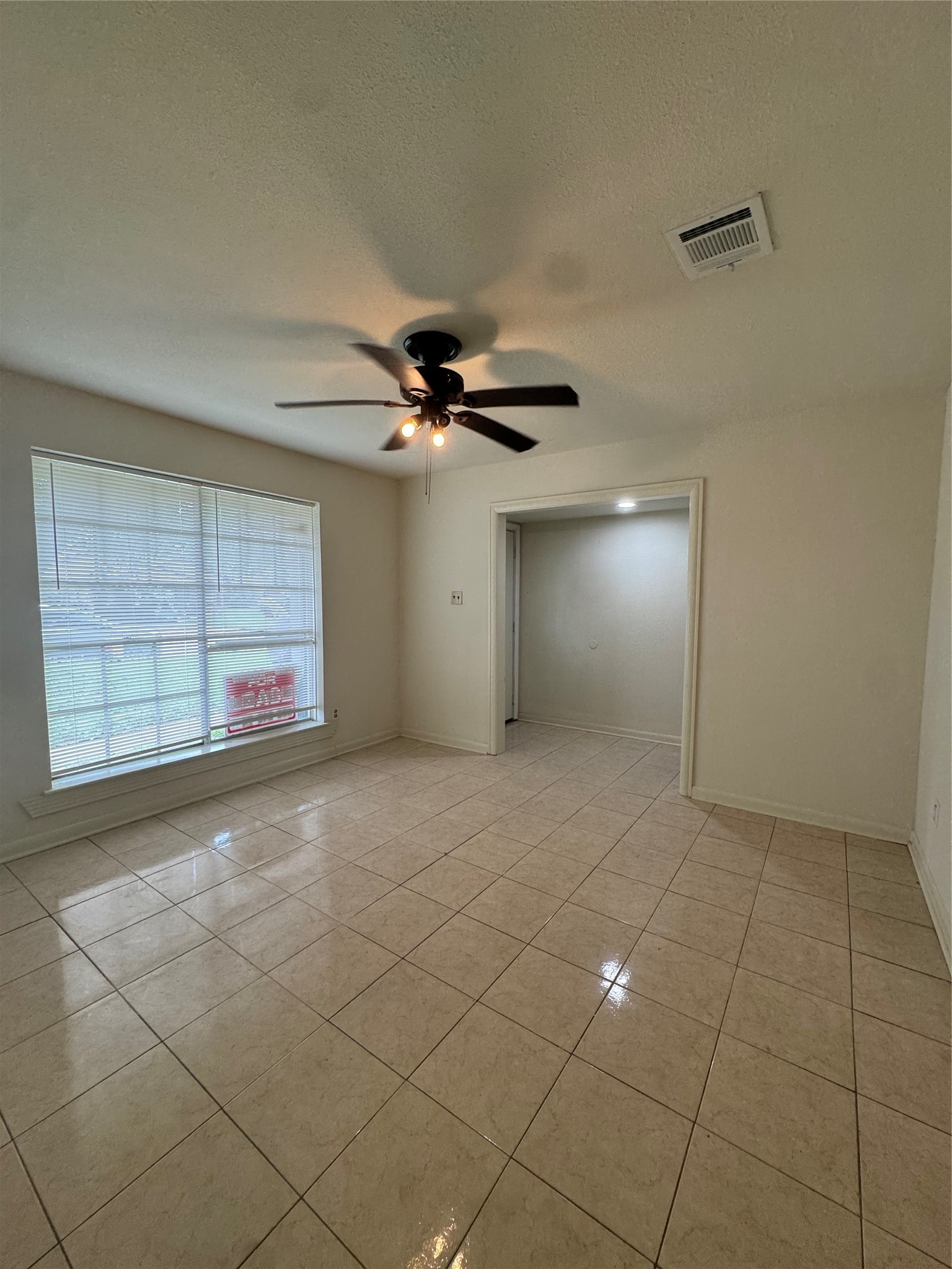 1443 Willow Rock Road Houston, TX 77088 - Photo 5 of 27 a view of an empty room with a window